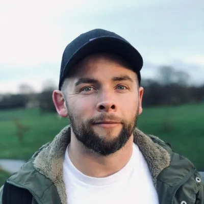 Toby Retallick, outdoors in a cap and a green jacket